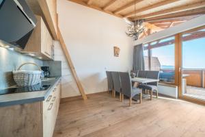 a kitchen and dining room with a table and chairs at Eggerhof Familiennestl in Verano