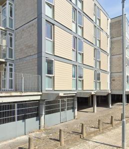 an apartment building with a fence in front of it at Abez Accs in Portsmouth