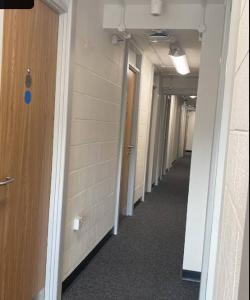 a hallway of an office building with a long corridor at Abez Accs in Portsmouth