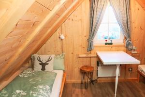 a tiny house with a bed and a desk at Villa Wolfsgrund und Apt Wolfshöhle in Schluchsee