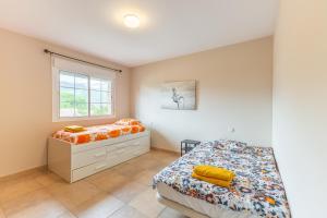 a bedroom with a bed and a window at El Castillo in La Adrada