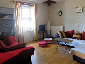 a living room with a couch and a table at Domaine De Chante-Oiseau - 28 pers in Theil-Rabier