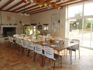 a large dining room with a long table and chairs at Domaine De Chante-Oiseau - 28 pers in Theil-Rabier