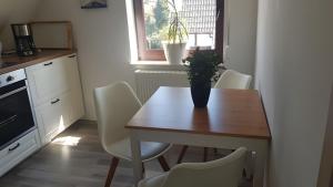 a kitchen with a wooden table with a vase on it at Fewo Drei Gleichen Nr 1 in Wandersleben