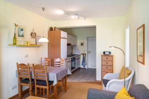 a kitchen and dining room with a table and chairs at Möve Aba Appartment 11 in Rerik
