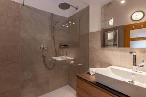 a bathroom with a shower and a sink at Funtnatsch Apartment Langkofel in Laion +32 photos