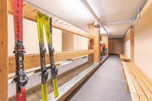 a room with skis on the shelves in a building at Mountain View Corones in Reischach