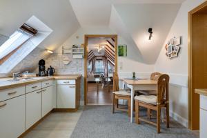 a kitchen with a table and a dining room at Haus Hachmann Wesselburen in Wesselburen