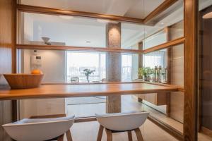 a kitchen with a table and two chairs and a window at Santa Teresuca en Santander in Santander