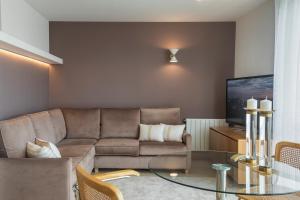 a living room with a couch and a glass table at Santa Teresuca en Santander in Santander