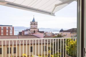 a view from the balcony of a building with a clock tower at Santa Teresuca en Santander in Santander