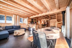 a living room with a blue couch and a table at Chalet Le Mas Devant in Morillon +26 photos
