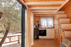a room with a kitchen and a large window at Bali House in Peypin