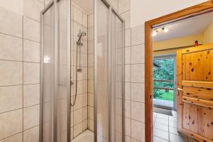 a shower with a glass door in a bathroom at Krüseliner Mühle - Ferienwohnungen in Krüselin +150 photos