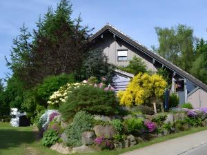 a house with flowers in front of it at Ferienwohnung Besamia in Todtnau