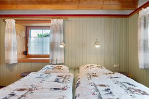 a bedroom with two beds and a window at Ferienwohnung Besamia in Todtnau