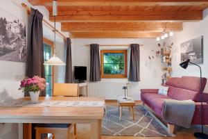 a living room with a red couch and a table at Ferienwohnung Besamia in Todtnau