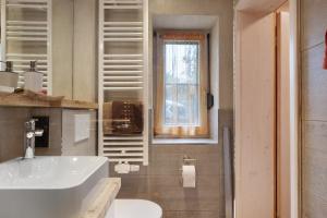 a bathroom with a white sink and a window at Ferienwohnung Besamia in Todtnau +24 photos