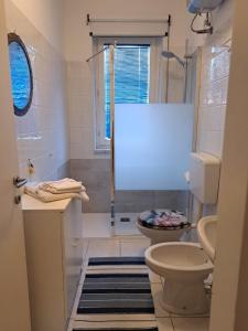 a bathroom with a toilet and a shower at Casa vacanze al Boschetto in Masina +11 photos