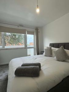 a bedroom with a large white bed with a window at fir tree in Southampton