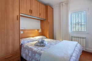 a bedroom with a bed with shoes on it at Maison La Coquette L' Escala in L'Escala