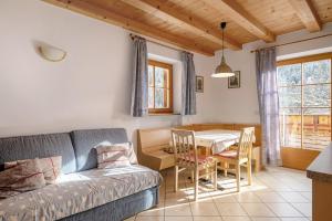 a living room with a couch and a table at Heinzenhof Welschnofen in Nova Levante