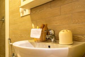 a bathroom sink with a toilet paper holder on it at Modern Practical Studio In Sauze in Sauze d'Oulx