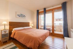 a bedroom with a bed and a balcony at Sant Rafel House in Arenys de Mar