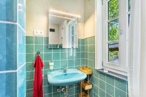 a bathroom with a blue sink and a mirror at Haus Berlar in Bestwig +75 photos