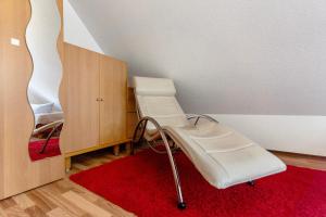 a room with a hospital bed and a red rug at Ferienhaus Waldfee in Reutin