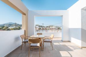 a dining room with a table and chairs on a balcony at Velvet Apartments in Rhodes Town