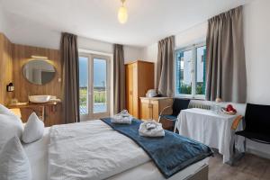 a hotel room with a bed with towels on it at Haus Burger Vilpian in Vilpiano