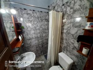 a bathroom with a sink and a toilet and a shower at Casa Manipa -3 dormitorios in Cafayate