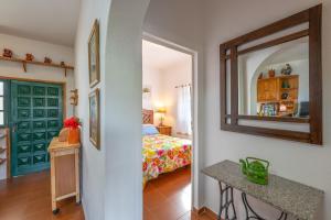 a bedroom with a bed and a mirror in a room at Casa Isabel in Tijarafe