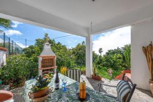 a patio with a table and a bird feeder at Casa Isabel in Tijarafe