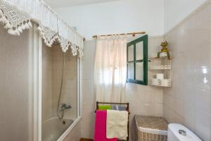 a bathroom with a tub and a shower and a sink at Casa Isabel in Tijarafe +21 photos