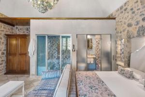 a bedroom with a large bed and a chandelier at Romantico casale di lusso con Spa in Conca dei Marini
