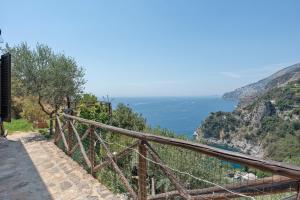 a view of the ocean from the side of a cliff at Romantico casale di lusso con Spa in Conca dei Marini