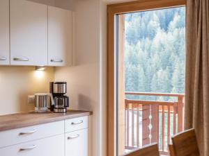 a kitchen with a coffee maker on a counter next to a window at Radlspitz Maurerhof in Valdurna