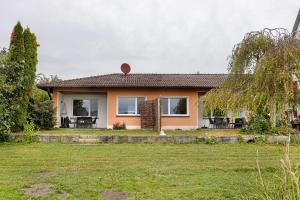 a house with a grass yard in front of it at Seeluft direkt am Wasser in Reichenau