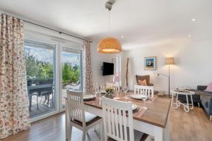 a dining room and living room with a table and chairs at Wohlfühlhaus in Freiamt