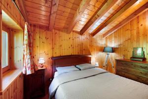 a bedroom with a bed in a wooden room at Anita Haus - Issime in Issime