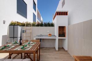 a kitchen with a table and a counter on a building at The Olive Tree Apartment in Tavira