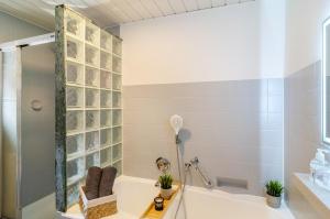 a bathroom with a tub and a shower at Fewo Jaeger in Bad Sachsa +29 photos