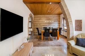 a living room with a table and a tv at Fewo Jaeger in Bad Sachsa