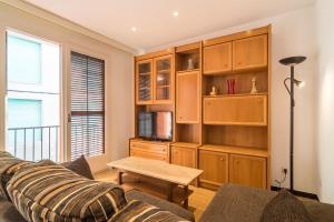 a living room with a couch and a table at Canet Beach 1 in Canet de Mar