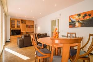 a kitchen and dining room with a table and chairs at Canet Beach 1 in Canet de Mar