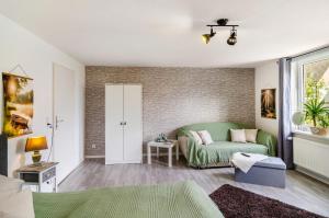 a living room with a couch and a table at Ferienwohnung am Vogler in Holenberg
