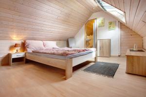 a bedroom with a bed in a wooden house at Ferienwohnungen Roth in Willingen