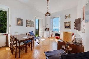 a living room with a dining room table and chairs at Bilo Costella in Bonassola